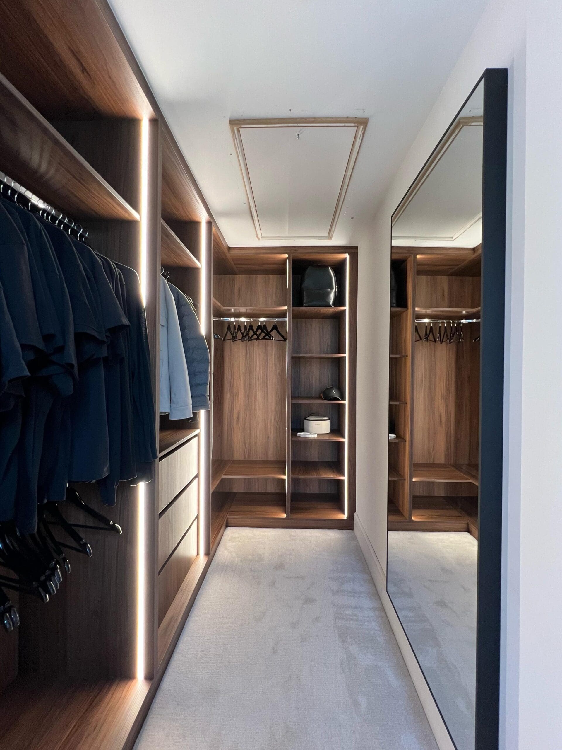 Bespoke walk in wardrobe featuring Warmia Walnut timber